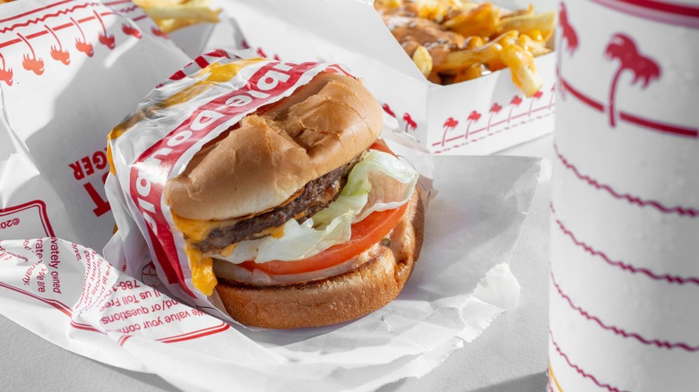 Unwrapped In-N-Out burger served with fries and a drink