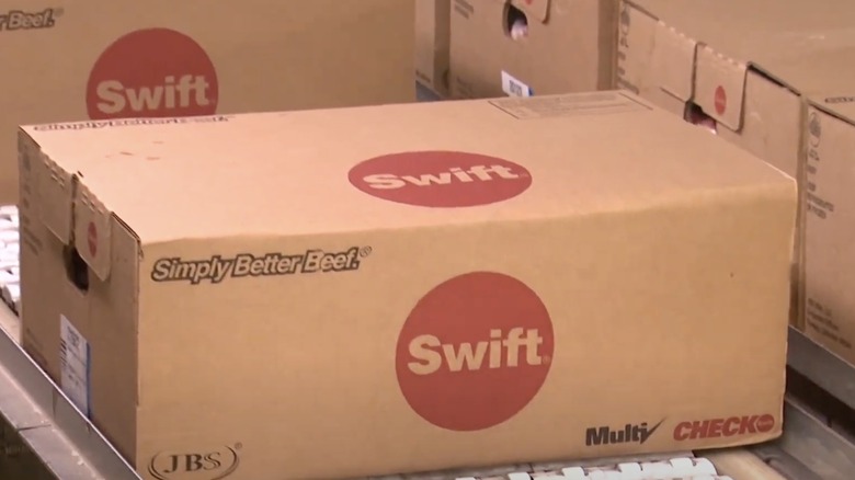 Cardboard cases filled with Swift Beef Co. beef on a factory line