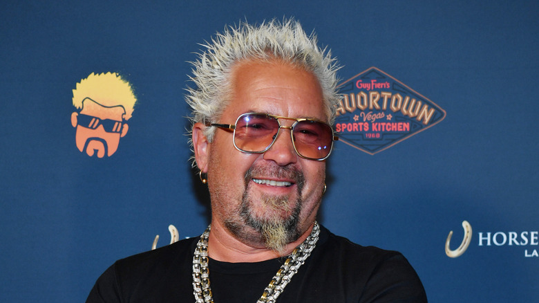 Guy Fieri smiling during the 2023 opening of the Las Vegas Flavortown