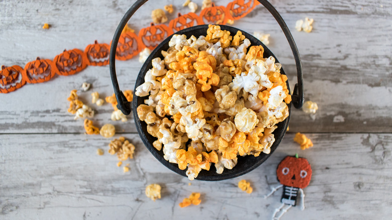 Bucket of popcorn near Halloween decorations
