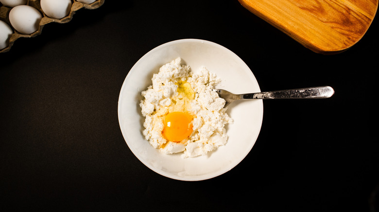 A bowl of cottage cheese and an egg