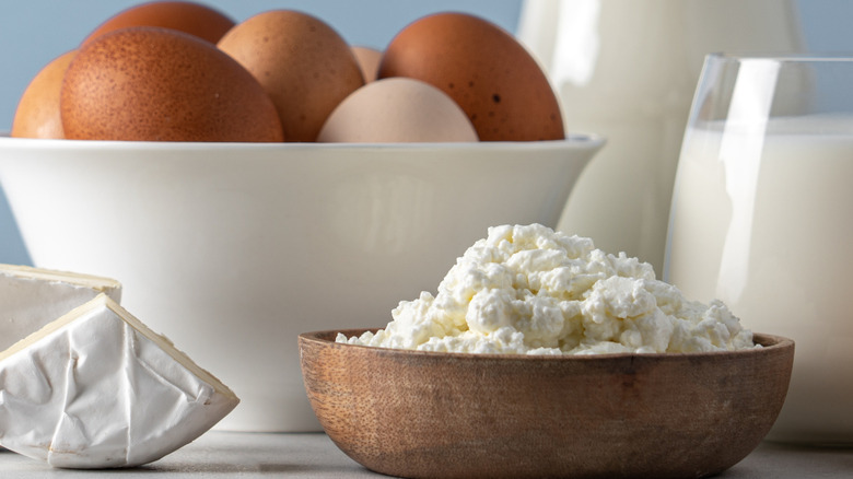 A bowl of eggs sits behind a bowl of cottage cheese