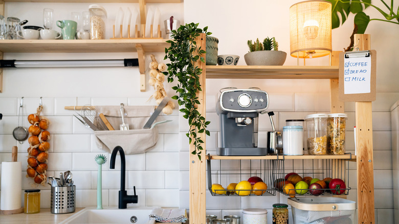 An organized kitchen with vertical storage, plants, plenty of light, and an espresso machine