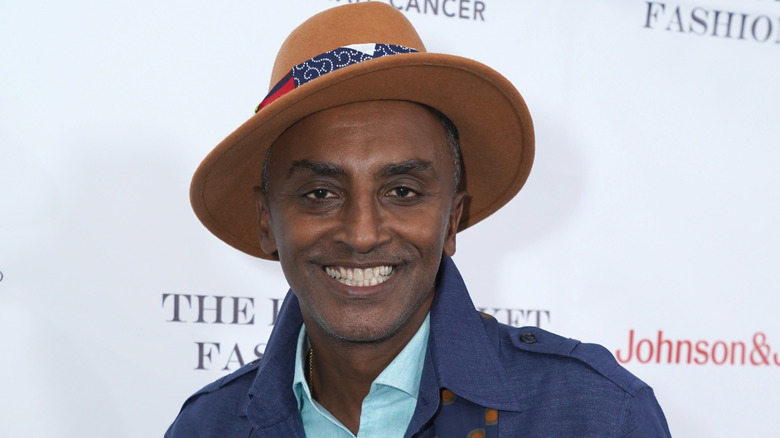 Smiling Marcus Samuelsson in a hat