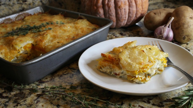 pumpkin and potato gratin on white plate with fork