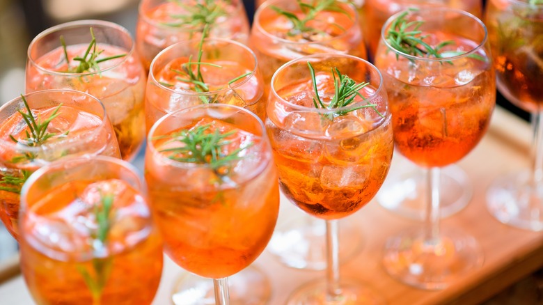 Aperol Spritzes garnished with rosemary