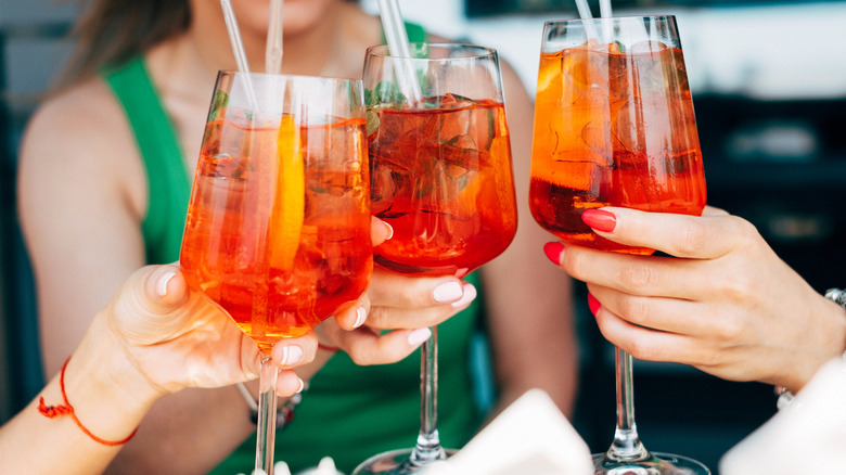 Women toasting Aperol spritz cocktails