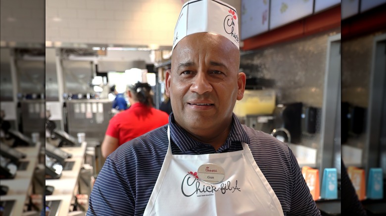 A Chick-fil-A store manager poses in store.