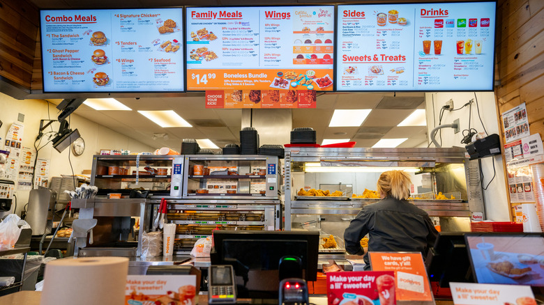 The ordering counter in a Popeyes restaurant.