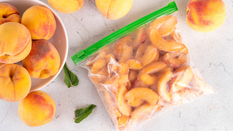Fresh peaches in a bowl and frozen peaches in a zip-close bag