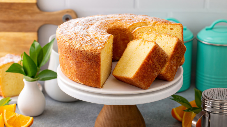 Freshly baked citrus Bundt cake slices sitting on a cake stand.