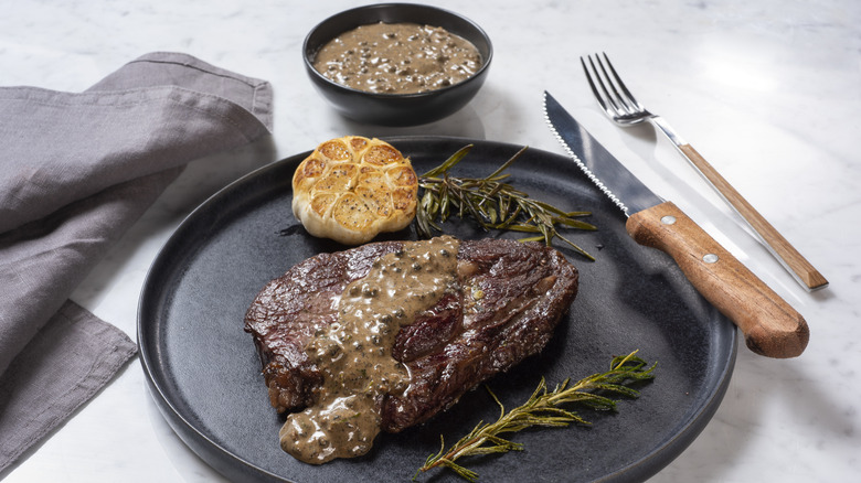 steak with roasted garlic, rosemary, and sauce
