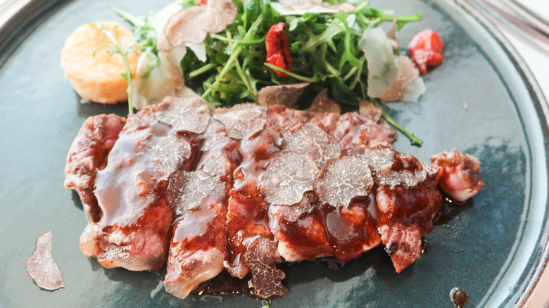 steak with barbecue sauce and black truffles