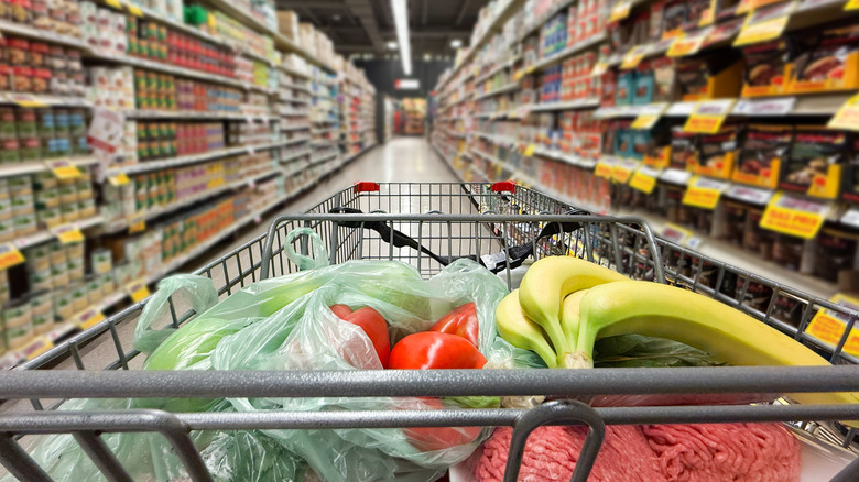 Shopping cart pictured in a grocery store.