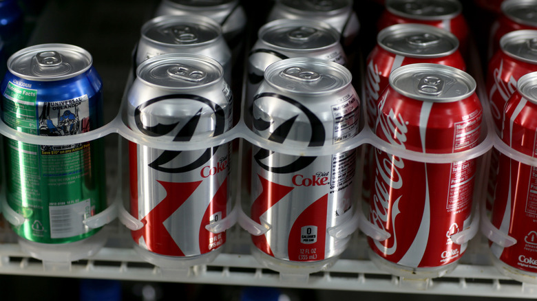 Several soda brands in a vending machine.