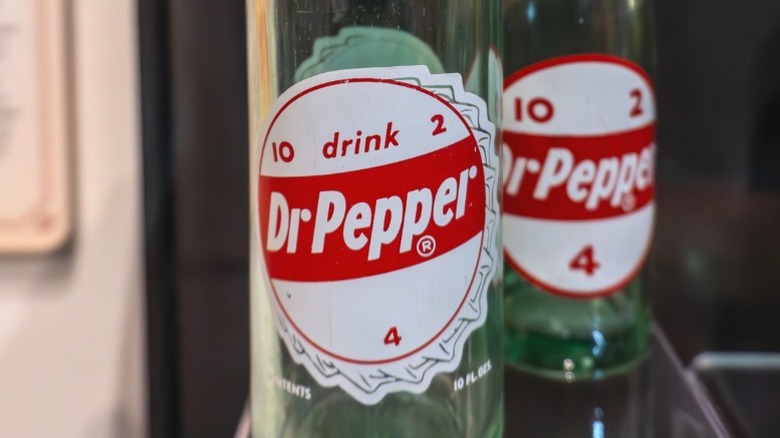 Vintage Dr Pepper bottles featuring the numbers 10, 2, and 4