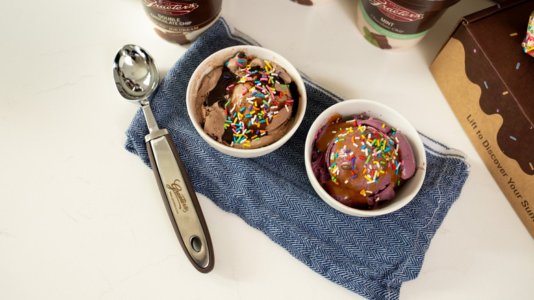 Two bowls of Graeter's ice cream with sprinkles sit on a cloth towel