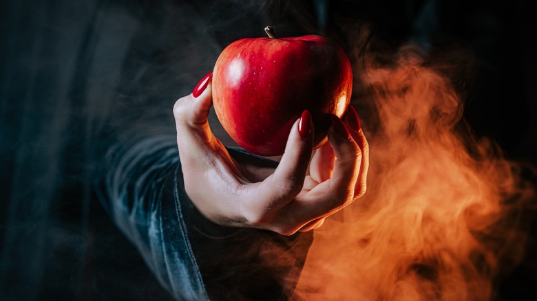 Woman's hand holding Halloween apple