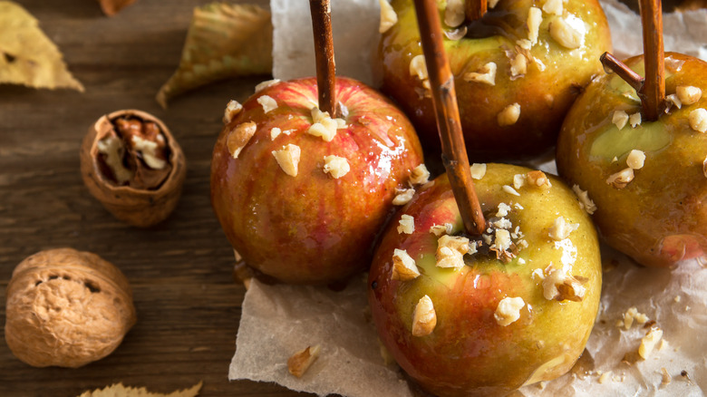 Candied apples on sticks with nuts