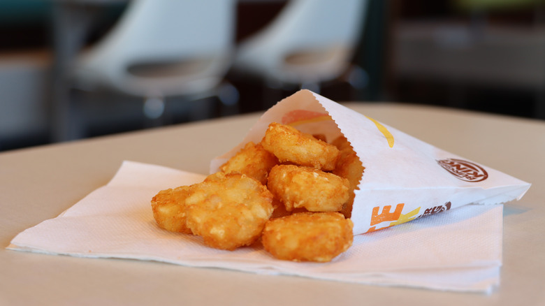 Burger King hash browns sit on a table inside a restaurant