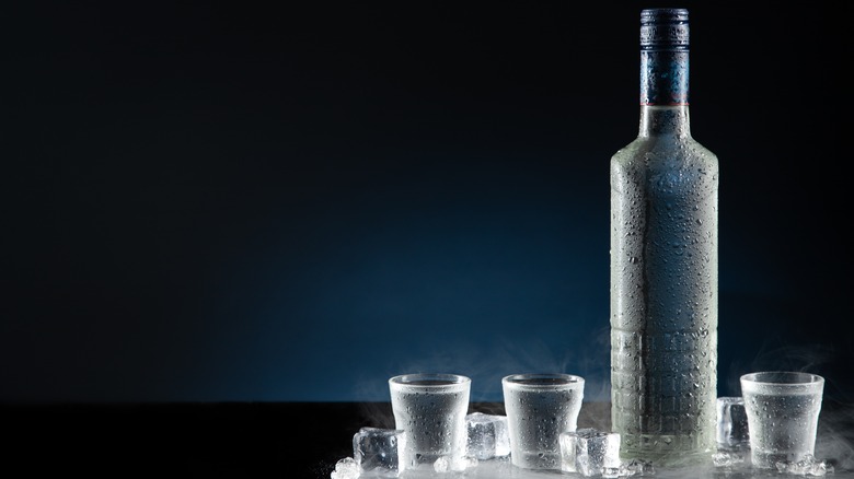 A bottle of vodka with shot glasses