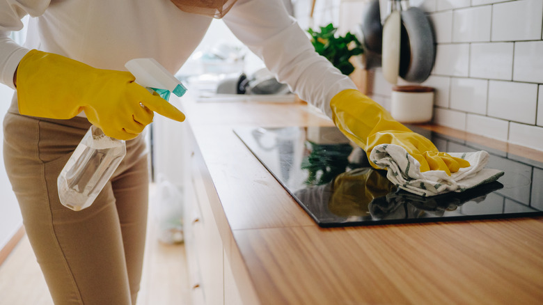 Person wiping a stove