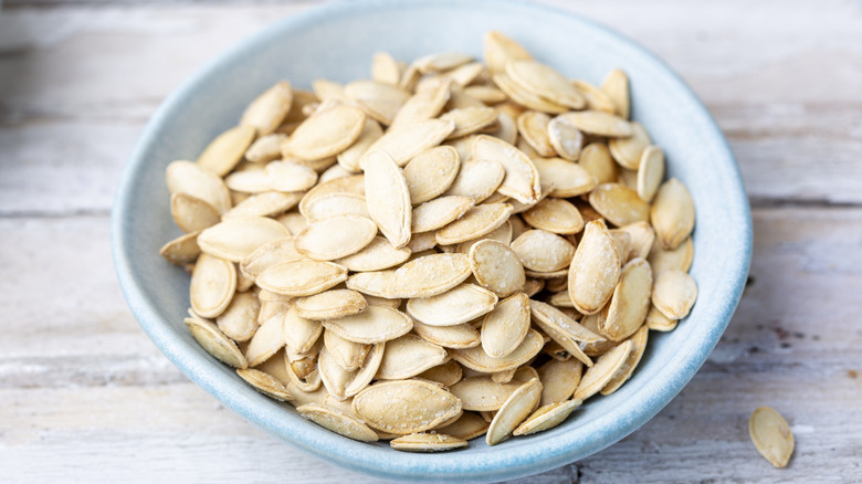 A bowl of pumpkin seeds.