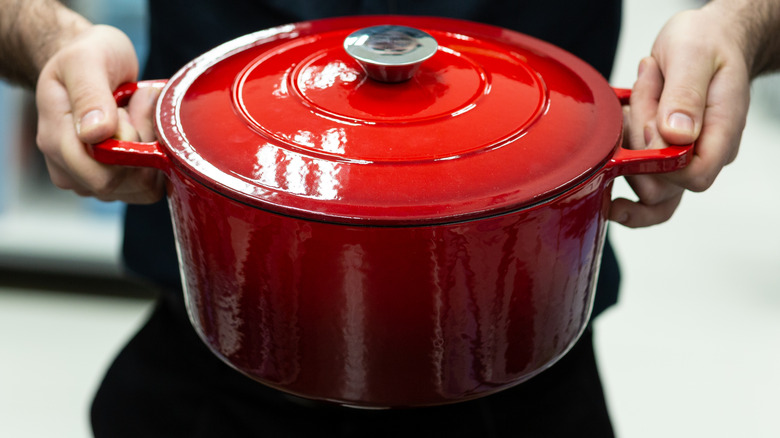 man holding cooking pot in hands