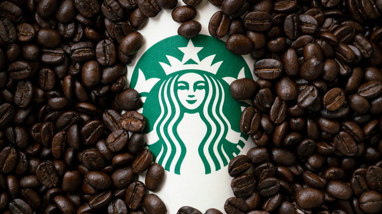 coffee beans surrounding starbucks cup