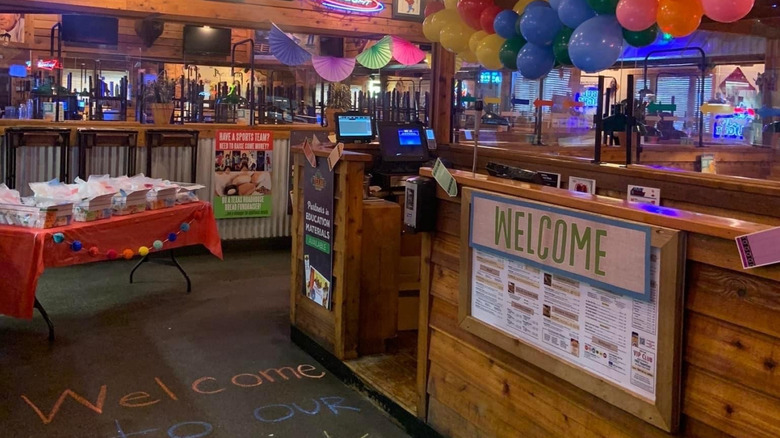 The entrance of a Texas Roadhouse restaurant is brightly decorated