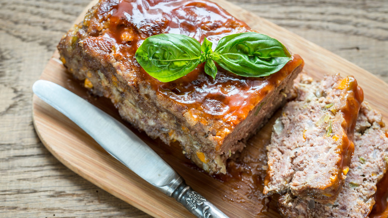 Meatloaf on a cutting board with a knife