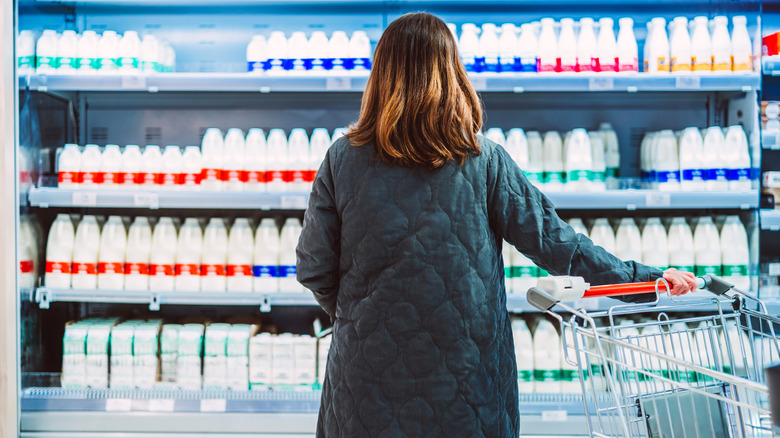 Person with back turned looking at milk