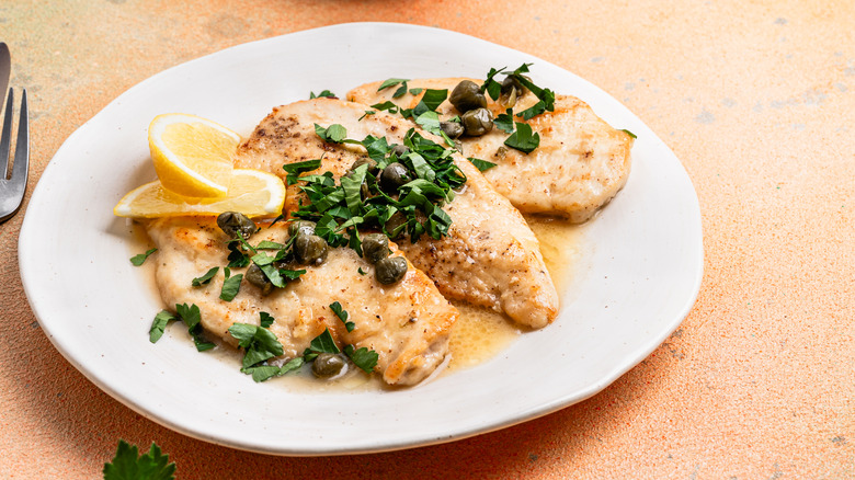 Plate of chicken with lemon and sauce