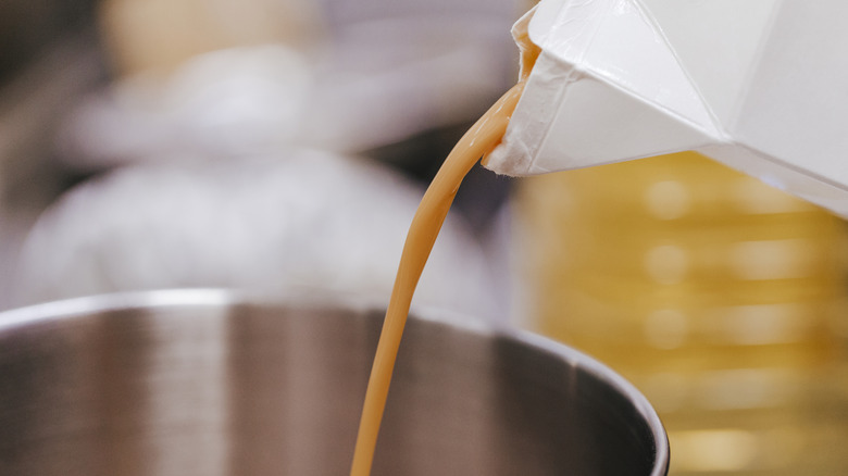 Pouring liquid eggs into a pot