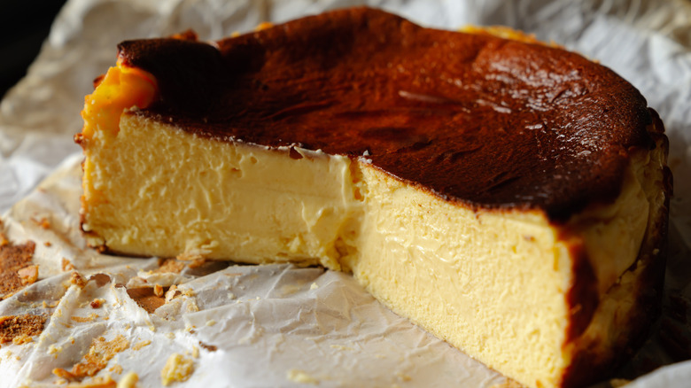 Half of Basque cheesecake on parchment