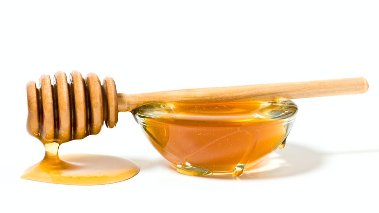 Bowl of honey and honeycomb dipper