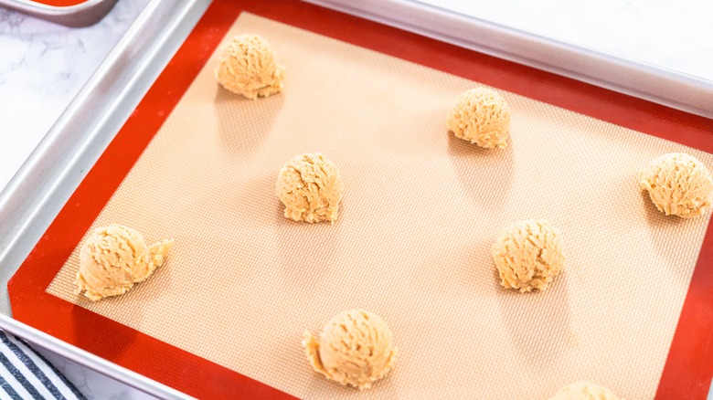 A silicone baking mat with cookie dough