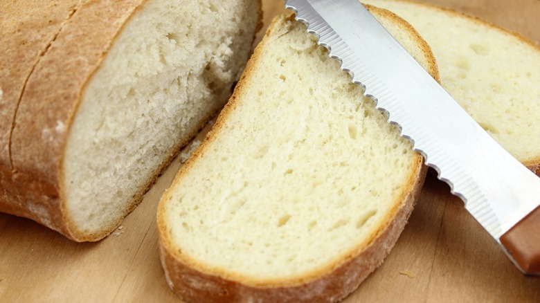 knife resting on top of bread