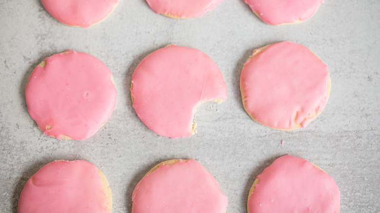 pink iced sugar cookies on countertop