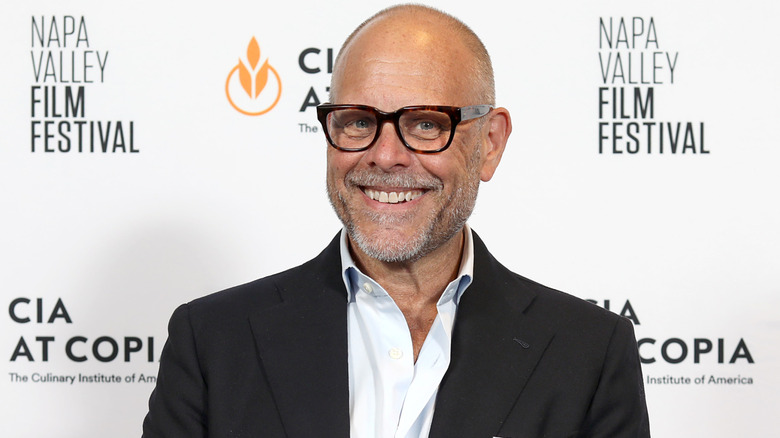 Alton Brown smiling at a event red carpet