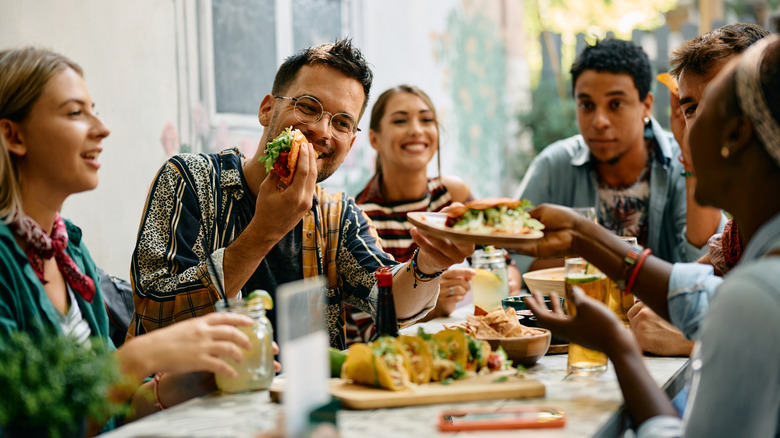 People eating togetherat a table.