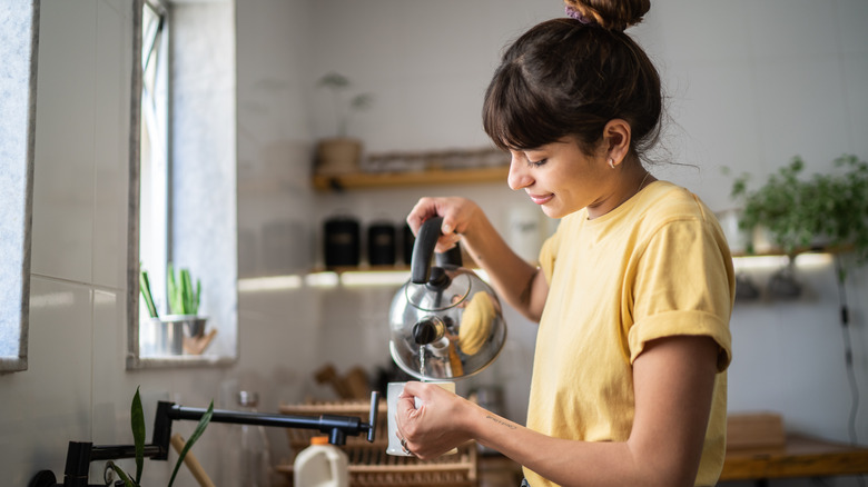 person making tea at home