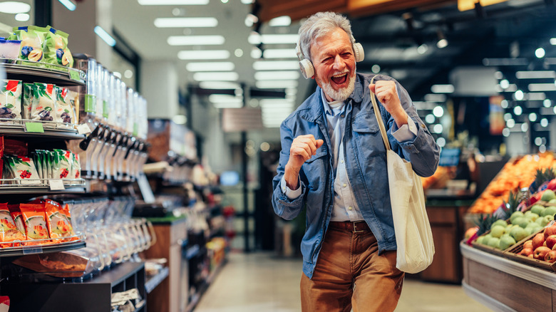 Person listening to music while grocery shopping.