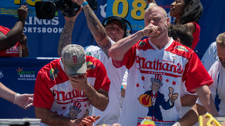 Two hot dog eaters, including Nick Wehry, compete at Nathan's Famous Hot Dog Eating Contest