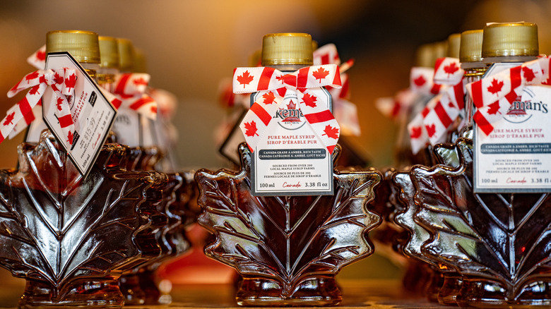 Rows of bottles of Canadian maple syrup with little bows that feature the Canadian national flag