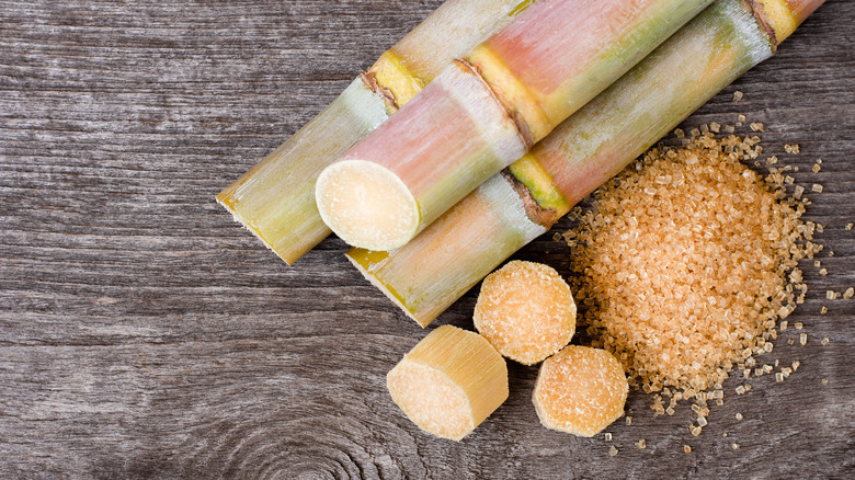 Sugar cane pieces and raw sugar