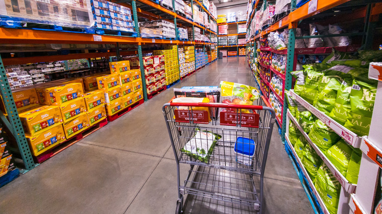 A shopping cart in a Costco aisle.