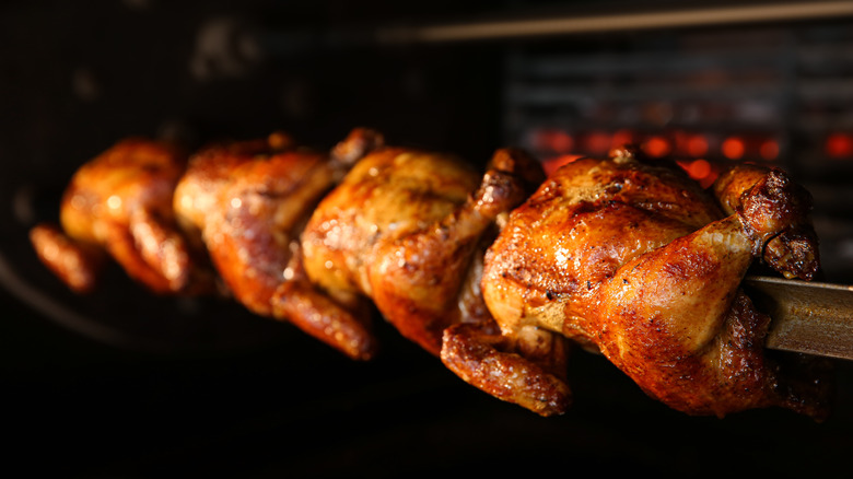 Rotisserie chickens on a spit