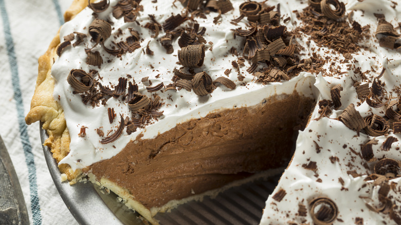 A homemade French silk pie with one slice taken out of it