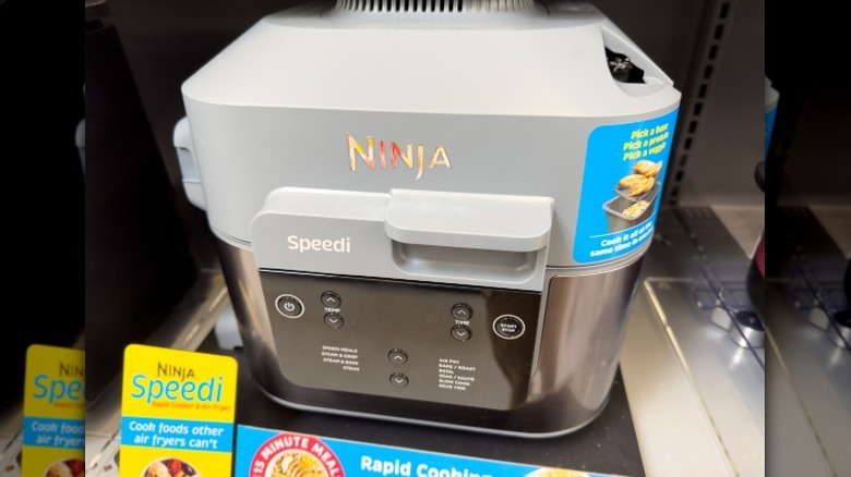 A Ninja Speedi sits on a display shelf in a retail store